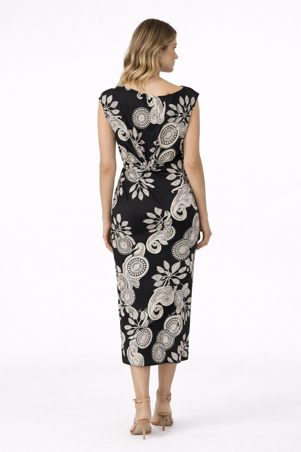 Woman wearing a black dress with white floral pattern on a white background
