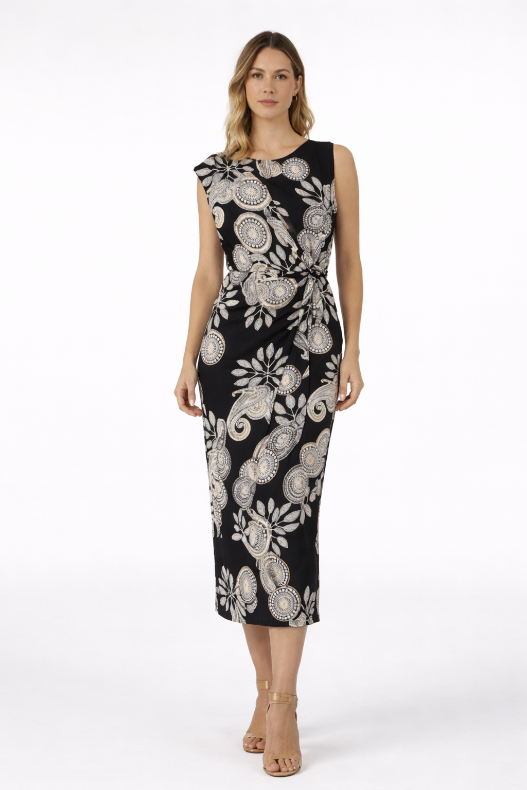 Woman wearing a black dress with white floral pattern on a white background